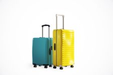 Two modern suitcases, one yellow and one blue, standing on a light background. Concept of travel, vacation, and holiday. 3D Rendering